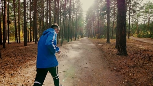 Male Runner Jogging In Park In Autumn Park