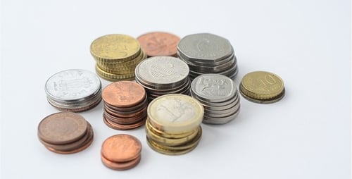 Pile of Coins Stacked on White Surface