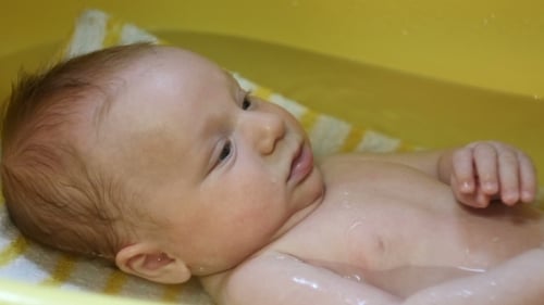 Adorable Infant Relaxing During Gentle Bath Time