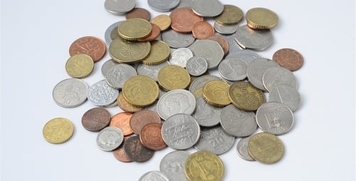 Collection of international coins scattered on a table
