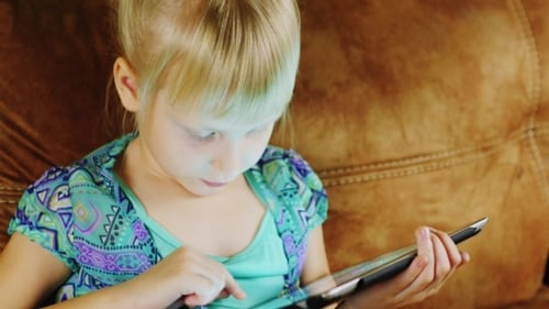 Funny Blonde Girl Playing On The Tablet Home