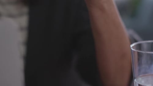 Close up of woman holding medication container at home