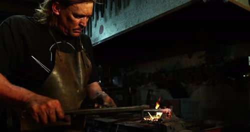 Blacksmith working on a iron rod