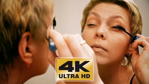 Woman Applies Mascara in Mirror Close Up