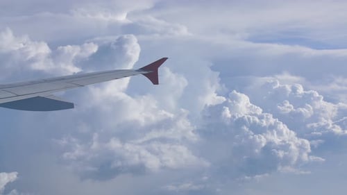 Storm Clouds and Part of the Wing of the Aircraft Window.