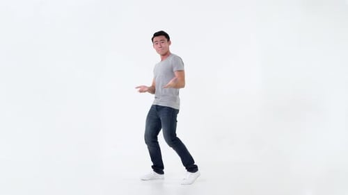 Man Dances Energetically in White Studio