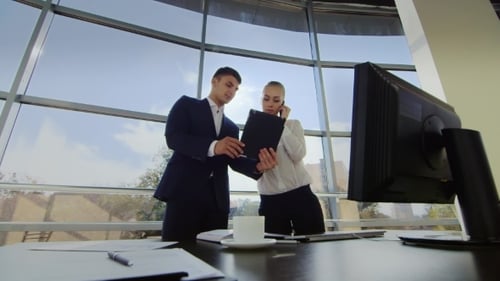 Two Young Men Working In The Office