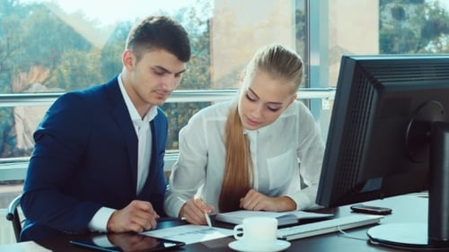 Two Young Men Working In The Office