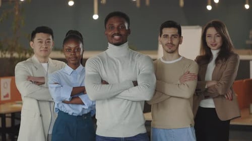 Portrait of Happy Business People Group Standing in Office Room Looking at Camera with Arms Folded