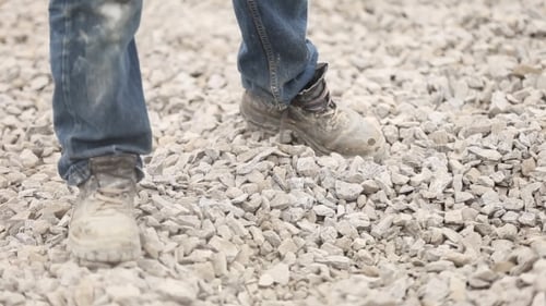 Worker Distributes Gravel