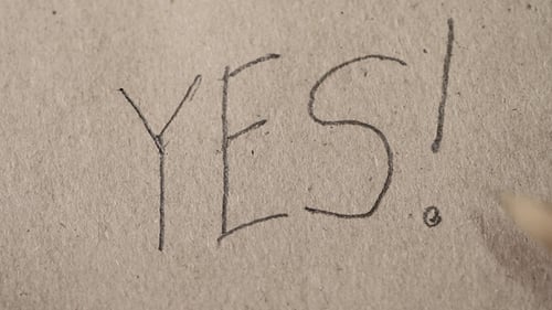 A Person Writes With a Pencil on Paper