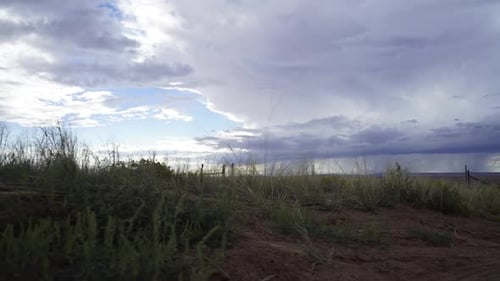 Clouds Roll Over a Rural Grassy Landscape