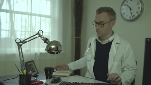 Doctor Working At His Office Desk 13