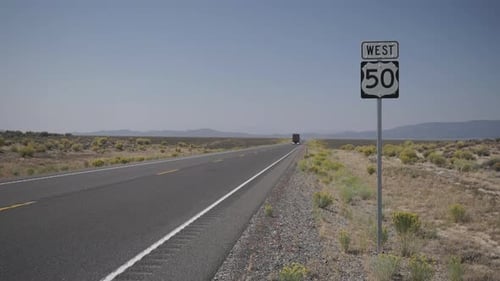 Big Rig Tractor Drives Along A Road In The Desert 1