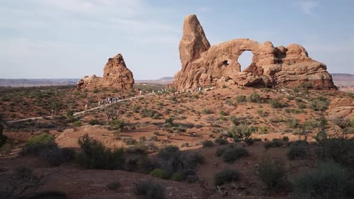 Crane Shot Of A Woman Drinking Water In Arches National Park 2