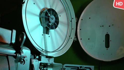 Vintage Film Projector Reel Spinning in Blue Light