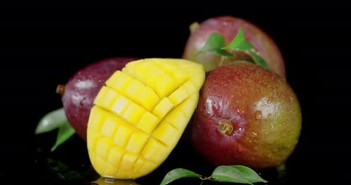 Whole and Half a Mango with Leaves Slowly Rotate.