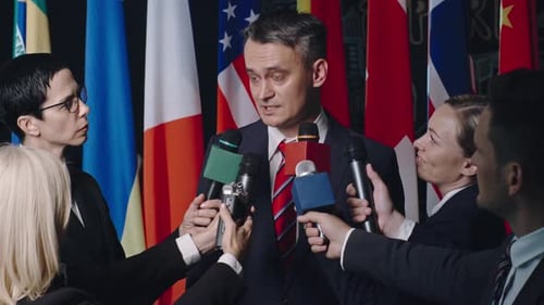 Man Answers Questions from Reporters at Press Conference