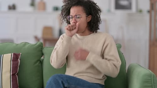 Woman Coughing on the Couch at Home