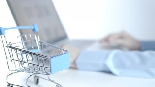 Online Shopping on Laptop with Miniature Cart