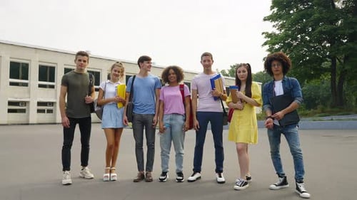 Group of Students Posing Against College Building