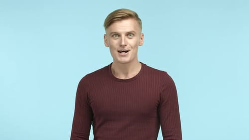 Man Smiles Brightly in Studio Close-up