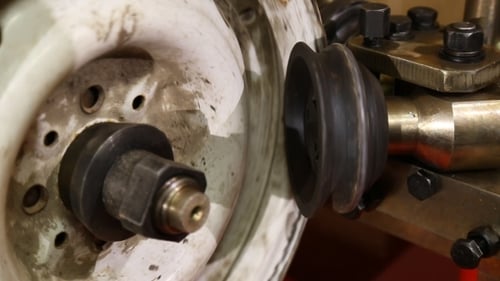 Machine Working on White Component Close-Up