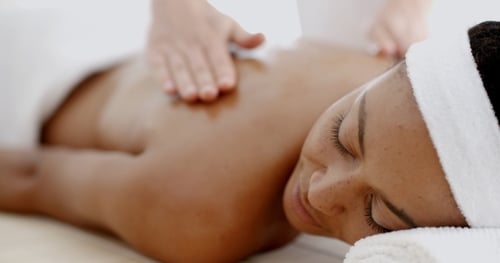 Woman Enjoying Relaxing Back Massage at Spa