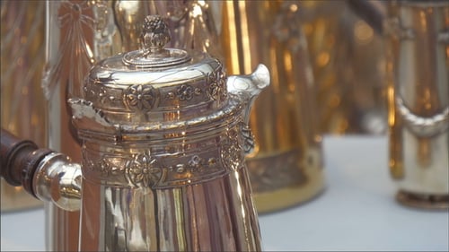 Antique Silver and Gold Teapots on Display