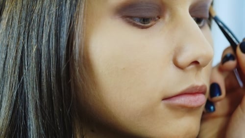 Young Adult Model Getting Eye Makeup Applied