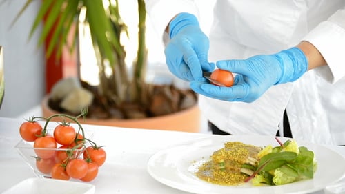 Chef Cuts Cherry Tomato for a Dish