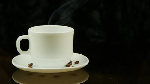Steaming Coffee Mug with Coffee Beans
