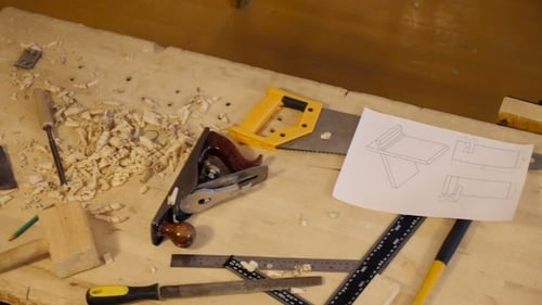 Carpentry Tools on Workbench with Technical Drawing