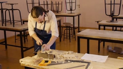 Man Carving Wood in Art Studio