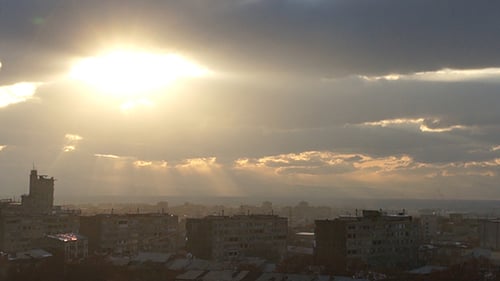 Dramatic Sunset over Urban Cityscape with Golden Rays