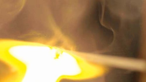 Match Ignites and Burns in Darkness Close Up