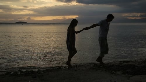 Sunset Silhouette Of Couple On The Beach