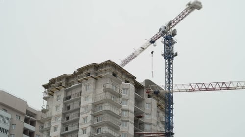 Building Under Construction with Tower Cranes in Urban Area