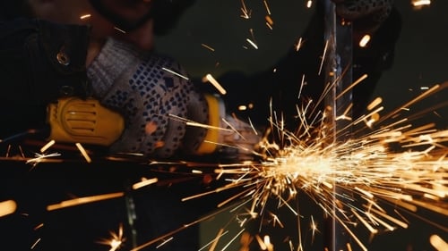 Worker Cutting Metal with an Angle Grinder