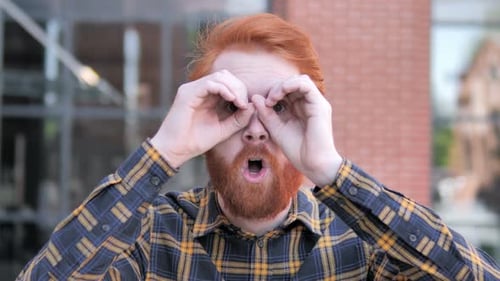 Man Makes Binoculars With Hands and Acts Surprised