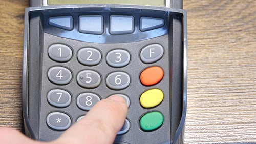 Hand Enters Numbers on POS System Keypad