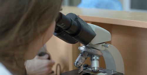 Scientist Works with Microscope in a Lab