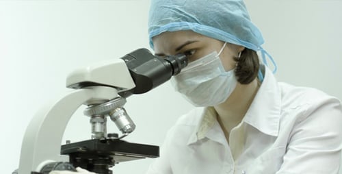 Female Doctor Working in Lab With Microscope