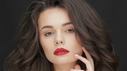 Elegant Woman with Wavy Hair and Red Lipstick