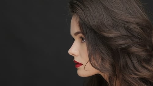 Brunette Woman with Red Lipstick Looks Over Shoulder