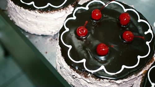 Chocolate Cake With Cherries In a Candy Store