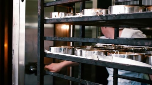 Baker Baking Cakes in an Industrial Oven