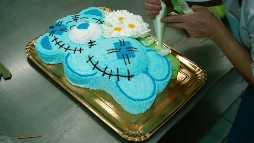 Woman Decorates Birthday Cake in Industrial Kitchen