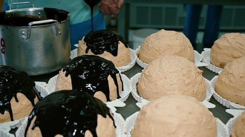 Pastry Covers Chocolate Cake In a Candy Store