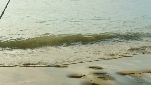 Ein Seil schwingt am Strand,